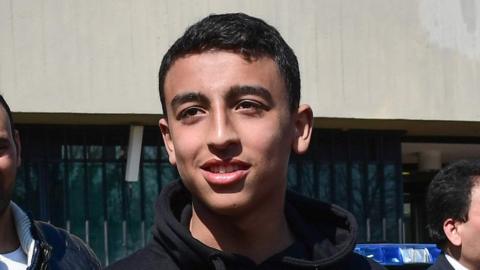 14-year-old schoolchild Ramy Shehata (C), who was able to call with his cell phone the Italian Carabinieri police for help during a schoolchildren hostage-taking situation on March 20 in San Donato Milanese, meets with some of the Carabinieri policemen who came for help,