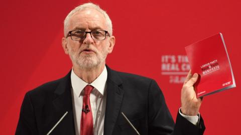 Labour leader Jeremy Corbyn holding the party's 'race and faith manifesto'