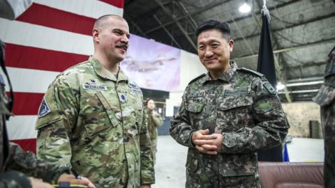 Lt. Col. Joshua McCullion (L), Commander of the US Space Forces Korea, talks with South Korean Gen. Ahn Byung-seok, deputy commander of the South Korea-US Combined Forces Command, at Osan Air Base on Wednesday