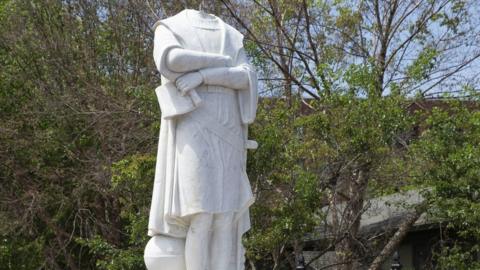 City employees inspect the decapitated statue of Christopher Columbus in Columbus Park in Boston, Massachusetts, 10 June 2020