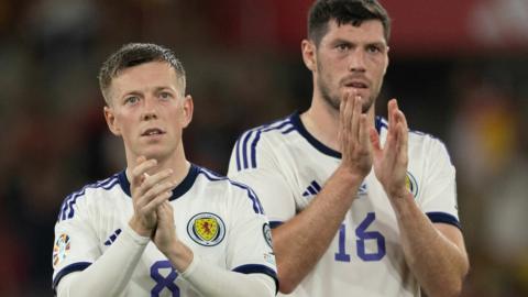 Scotland's Callum McGregor and Scott McKenna applaud the visiting fans