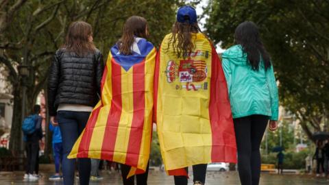 Girls wearing the Catalan and Spanish flags walk through Figueras, Catalonia on 30 September, 2017