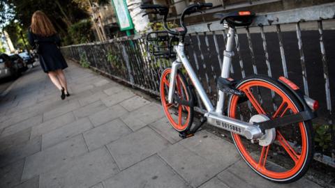 A Mobike left against railings