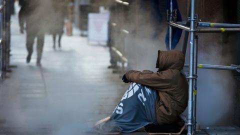 鶹Լless man sits outside in Canada