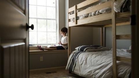 Child near a bunk bed