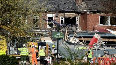 Emergency services work at the scene of a suspected gas explosion in New Ferry