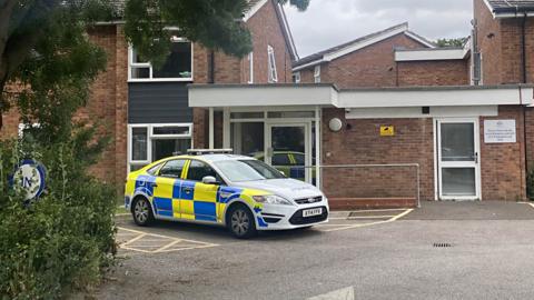 Police cars outside a temporary housing unit in Ipswich