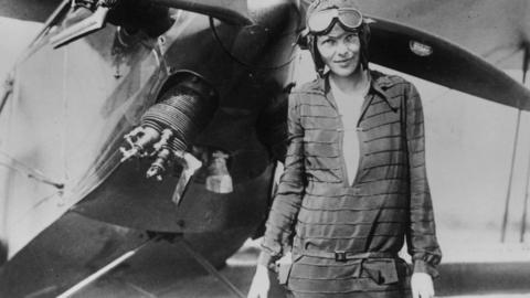 Amelia Earhart in front of a plane