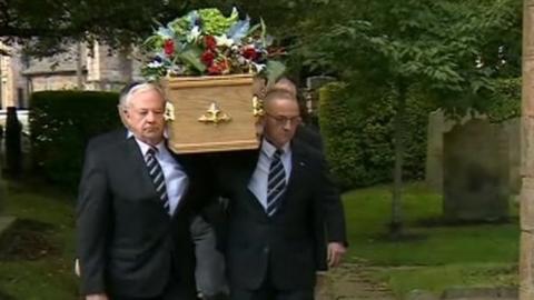 Mike Neville's coffin being taken towards the church