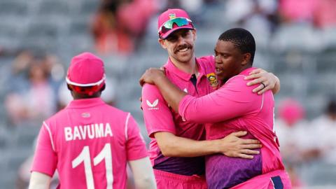 South Africa's Sisanda Magala (R) celebrates with teammate South Africa's Anrich Nortje (C) after dismissing Netherland's Paul van Meerken (not seen) during the second one-day international (