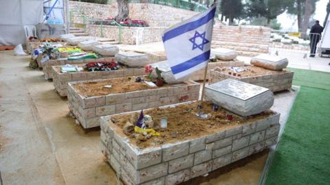 An Israeli flag is placed on the grave of a soldier that was killed in the Gaza Strip