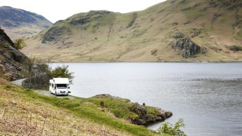 Stock image of a camper van parked at Crummock Water.