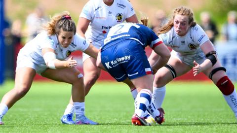 Exeter Chiefs players tackle a Bristol ball carrier