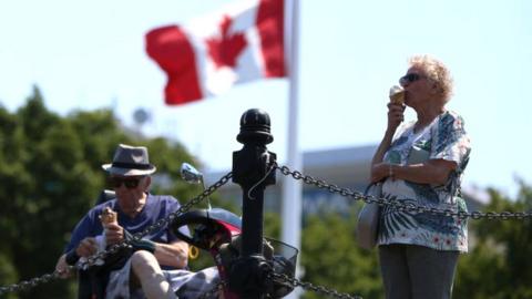 A couple eats ice creams as heat wave hits Western Canada on 30 June