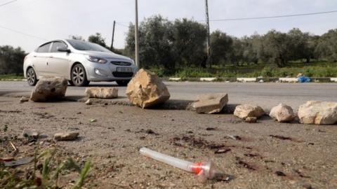 Palestinians check the area where three militants were killed, near the village of Araba, in the occupied West Bank (2 April 2022)