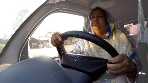 Asia driving a bus