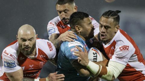 Hull KR players tackle a Leeds opponent