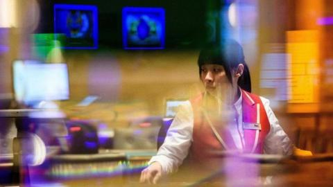 A member of staff prepares for the opening of a casino in Macau