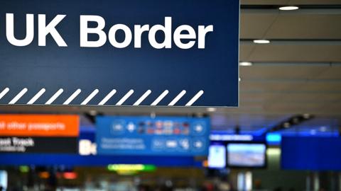 UK border signs are pictured at the passport control in Arrivals in Terminal 2 at Heathrow Airport in London