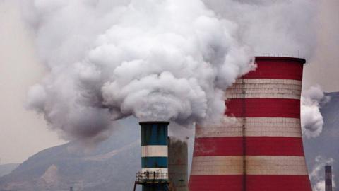 Smoke billows from a factory chimney in China