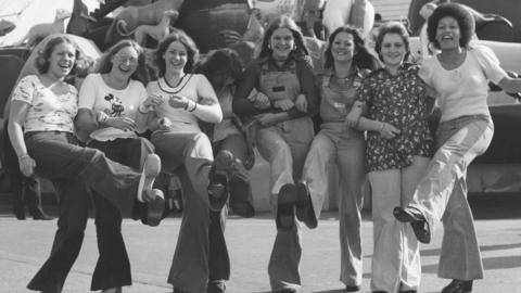 Littlewoods ladies posing for photo with ride in background, Littlewoods outing in Blackpool. 1973