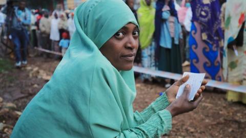 A woman waits to cast her vote at a polling station during the Ethiopian parliamentary and regional elections, in Beshasha, Ethiopia