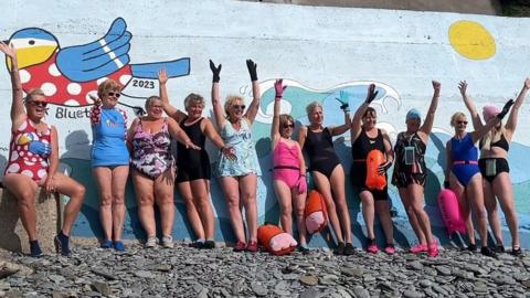 Manx Bluetits swimmers in front of the mural at Port Jack in Onchan