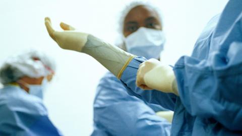 Doctors wearing scrubs and gloves