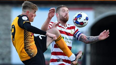 Will Evans of Newport County and Adam Clayton of Doncaster Rovers