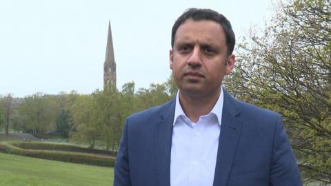 Scottish Labour leader Anas Sarwar stands in a park while campaigning in Glasgow