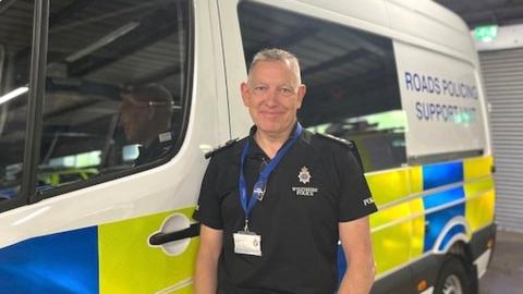 Police officer standing next to new van