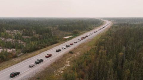 Yellowknife residents leave the city on Highway 3, the only highway in or out of the community, after an evacuation order was given due to the proximity of a wildfire in Yellowknife, Northwest Territories, Canada August 16, 2023. REUTERS/Pat Kane TPX IMAGES OF THE DAY