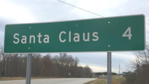 Santa Claus four miles away road sign
