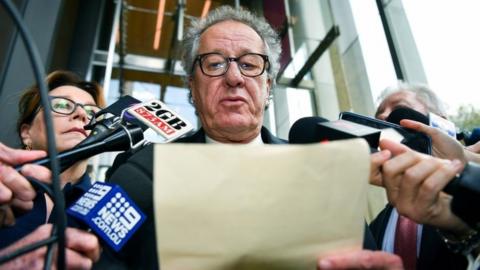 Geoffrey Rush talks outside court