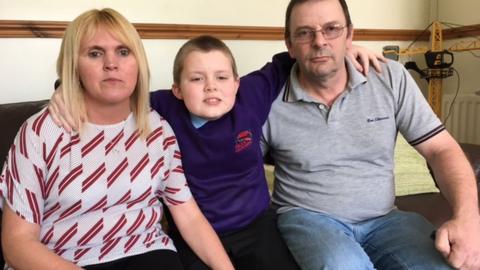 Reuben Lewis with his parents