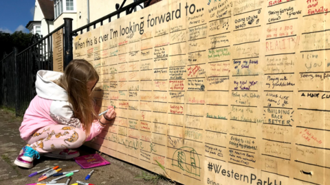 Young girl writes on wall