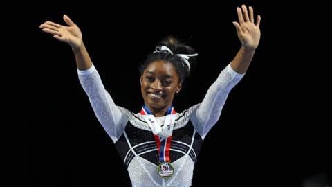 Simone Biles waves to the crowd at the US Classic