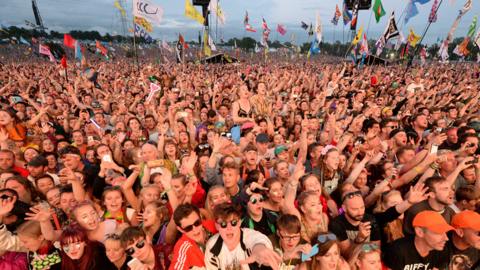 Festivalgoers watch the Pyramid Stage at Glastonbury Festival - 2017