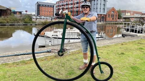 Mel poses for the picture behind his Penny farthing bike