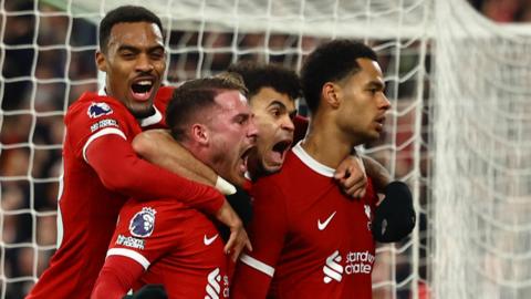 Liverpool players celebrate scoring against Luton