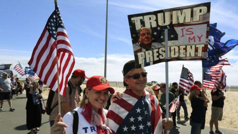 Supporters of US President Trump march during the "Make America Great Again" rally in Huntington Beach, California on 25 March 2017