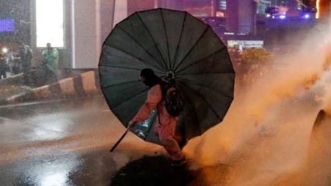 Protester with umbrella