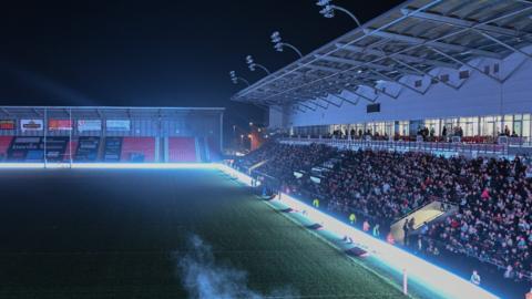 Leigh Sports Village is pitched into darkness after floodlight failure at the venue during Leigh v Huddersfield