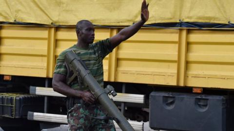 A mutinous soldier patrols in the streets of Ivory Coast's central second city Bouake, in May 14, 2017