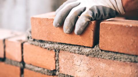 Bricklayer laying bricks