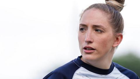 Caitlin Beevers looks on during a training session