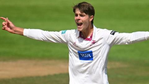 Archie Vaughan with arms outstretched appeals against Hampshire