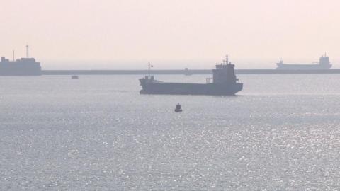 Three ships anchored in Plymouth Sound on a hazy day
