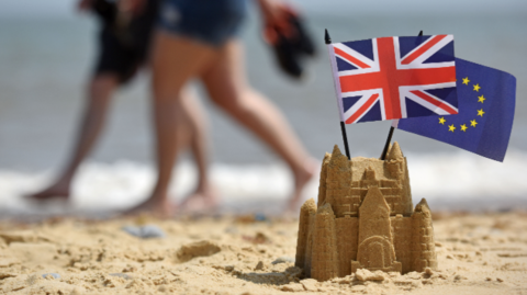 Sandcastle with EU and GB flags