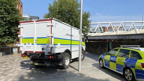 Bomb disposal vehicle and a police car